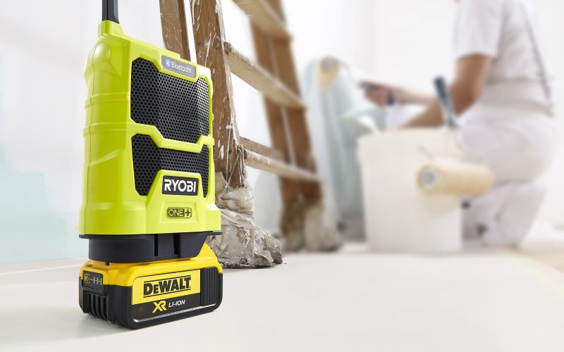 Ryobi radio with DeWalt battery in room being painted