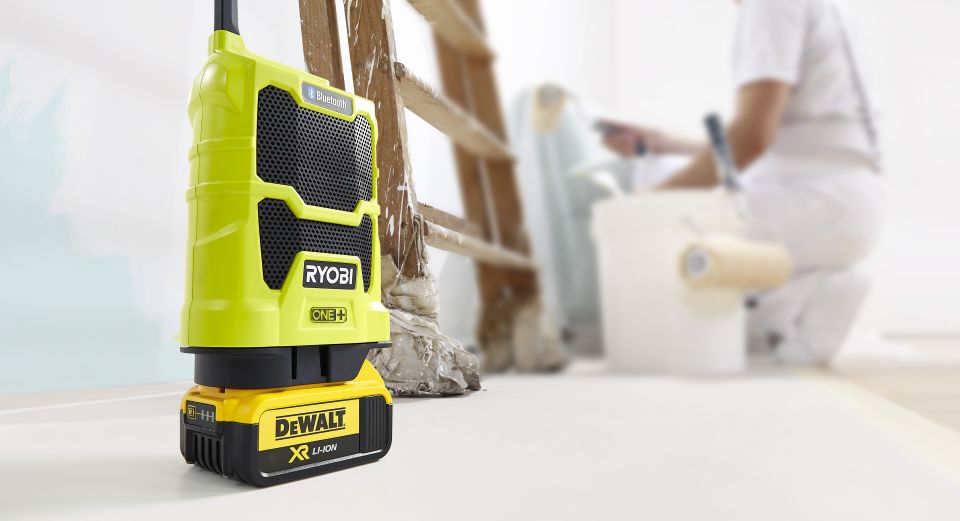 Ryobi radio with DeWalt battery in room being painted
