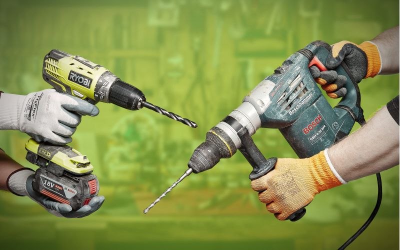Corded vs cordless drills on green background