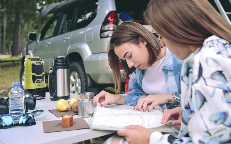 Women on outdoor adventure with radio in background