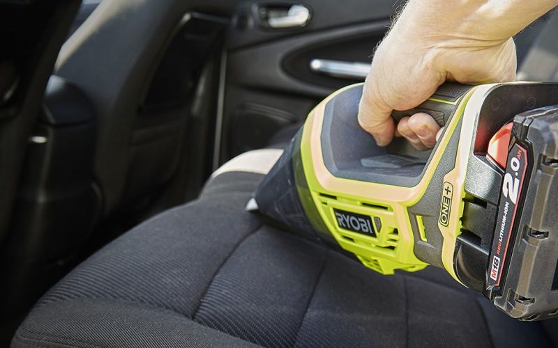 Ryobi One+ cordless vac cleaning car seat